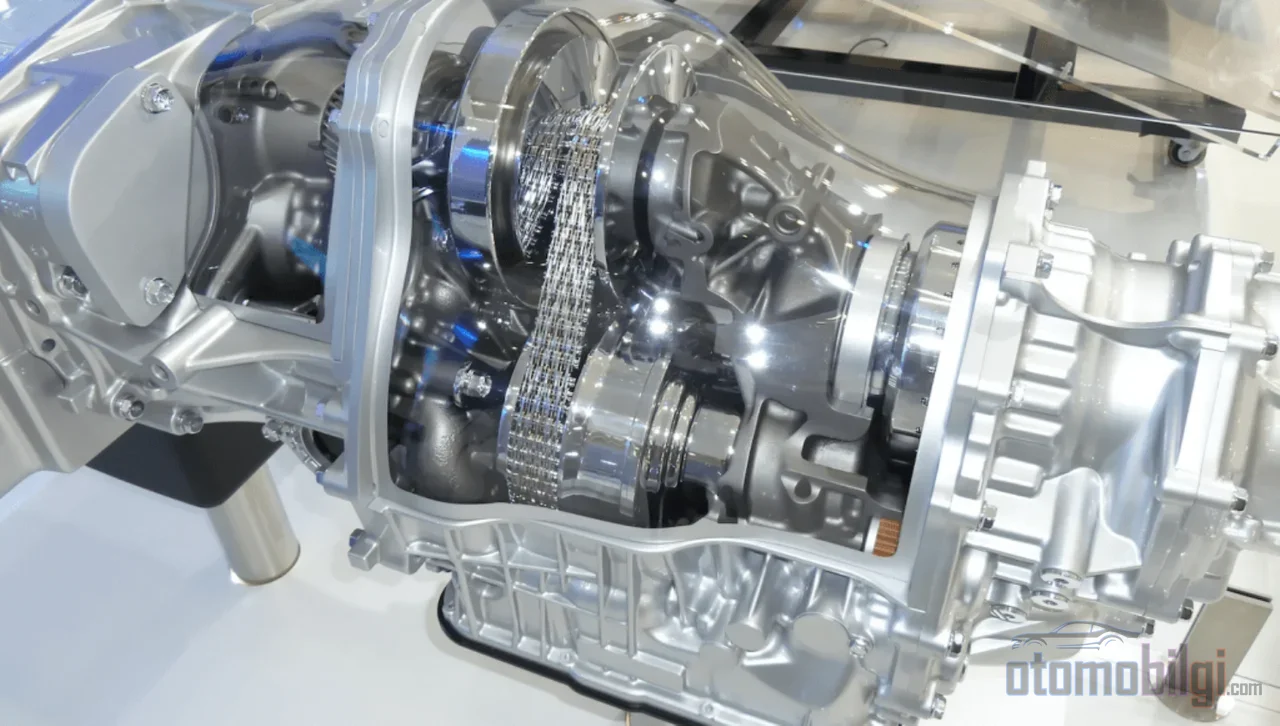 Kayışsız, vitessiz bu kutu bir CVT değil; iki elektrik motoru ve gezegen dişlisiyle gücü saniyede binlerce kez bölüştüren bir beyindir.