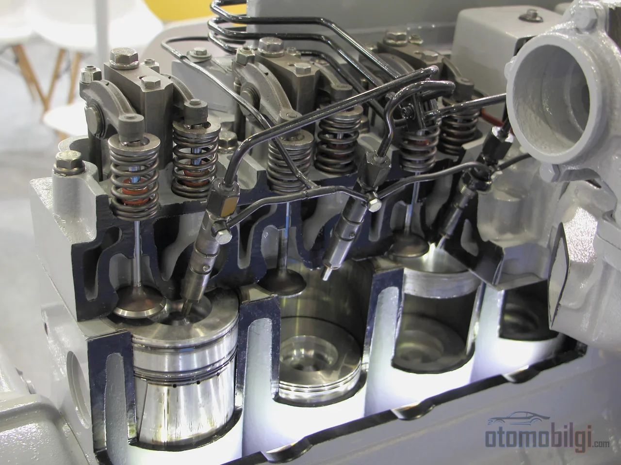 Direct injection operates at a pressure 50 to 100 times higher than port injection, and this difference determines the engine's entire character.